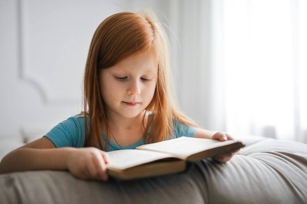 Girl in Blue T-shirt Reading Book